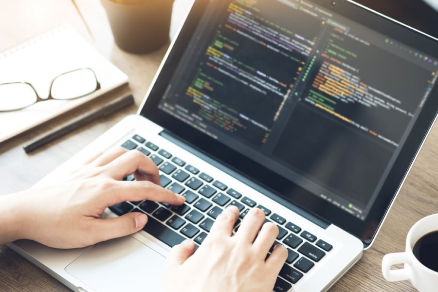Young programmer is developing and coding the software application.