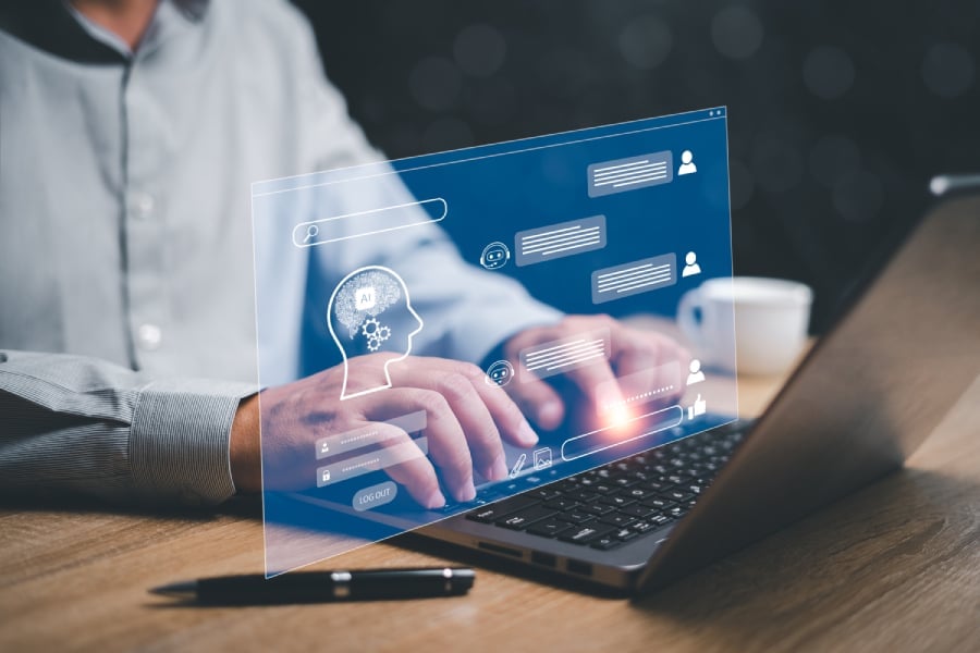 Businessman use laptop chatting with a smart AI chatbot developed by OpenAI.