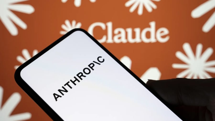 Anthropic on smartphone with Claude in the background.