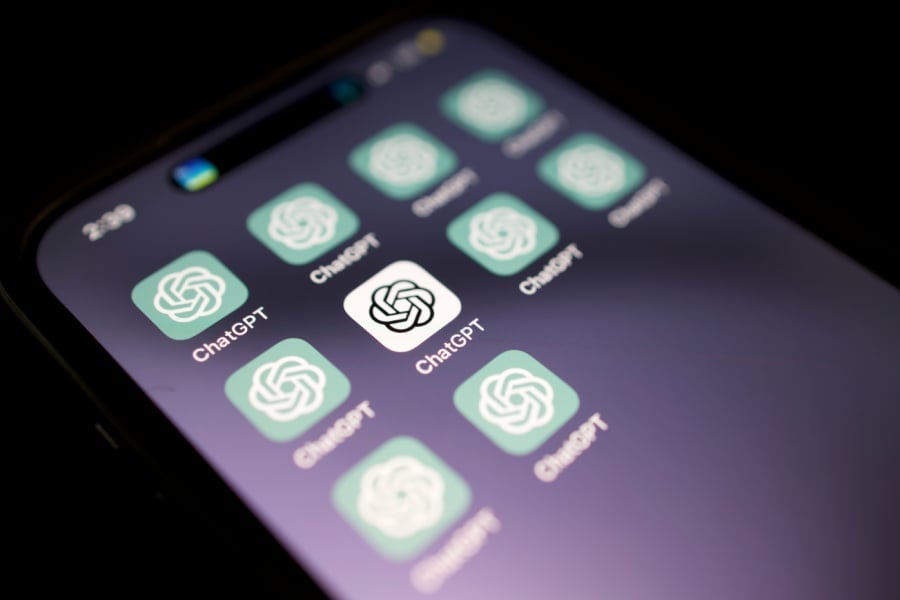 A close up of a cell phone with ChatGPT icons on it.
