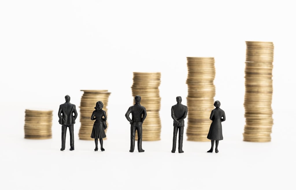 Scaled figures of people on background of stacked coins.