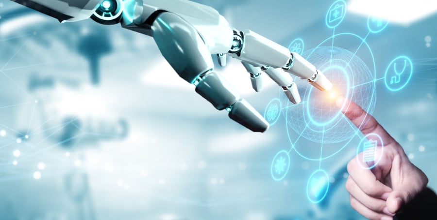 A robotic hand and human hand touching index fingers.