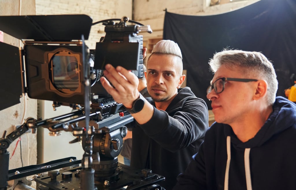 Professional videographer and film director working on a video equipment.