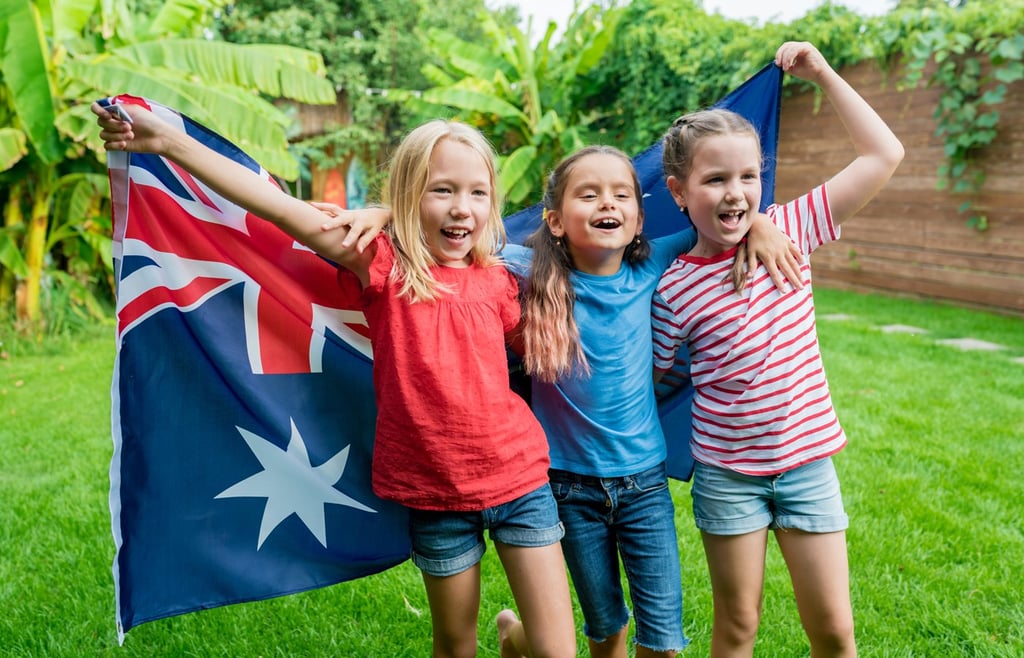 Australian kids holding the flag for Australia.