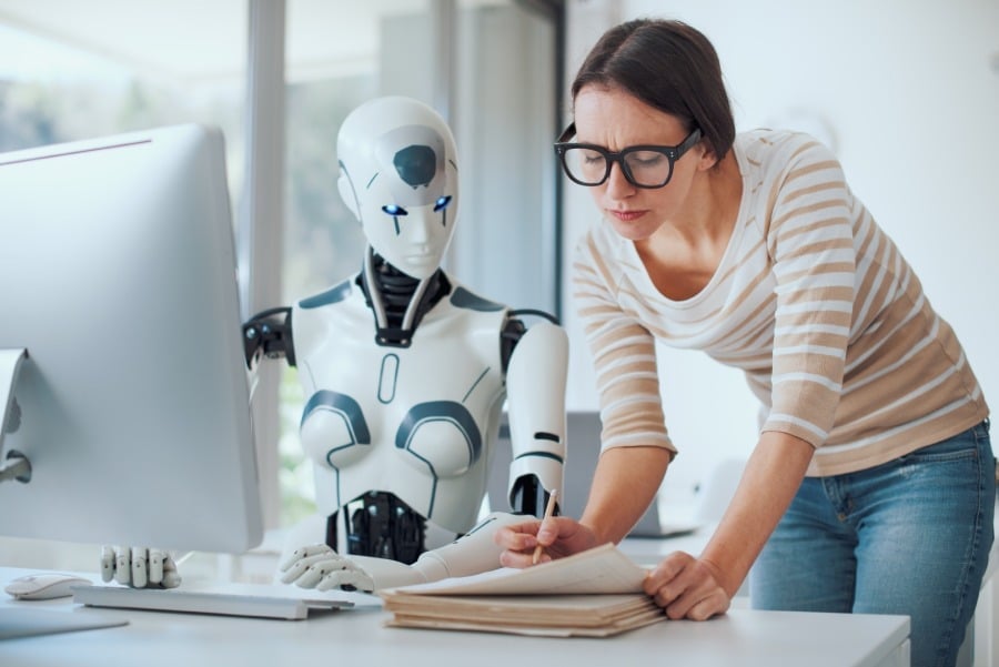 Woman and AI robot working together.