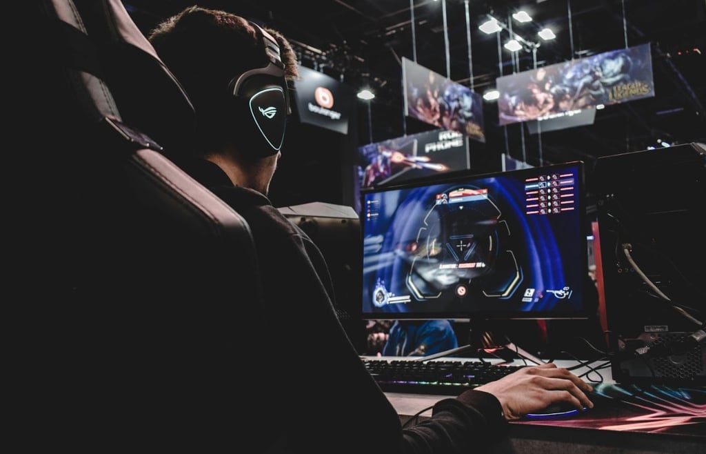 person sitting on gaming chair while playing video game