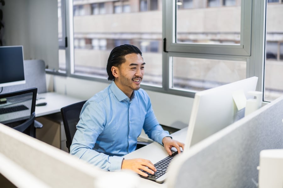 An employee working on his computer inside the office.