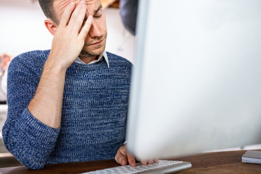 Stressed businessman working in an office.