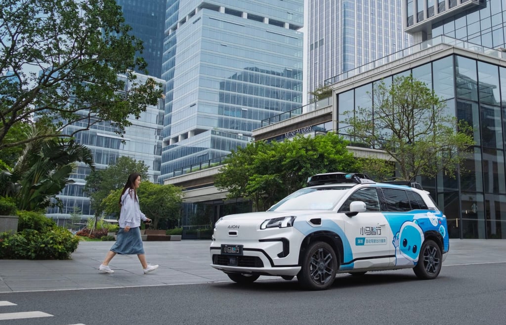 Pony.ai Gen-7 robotaxi based on the Toyota bZ4X or Aion V parked on a city street, with a person walking by
