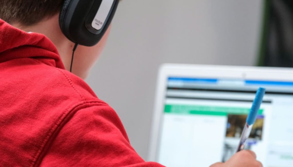 A person studying while listening with headphones