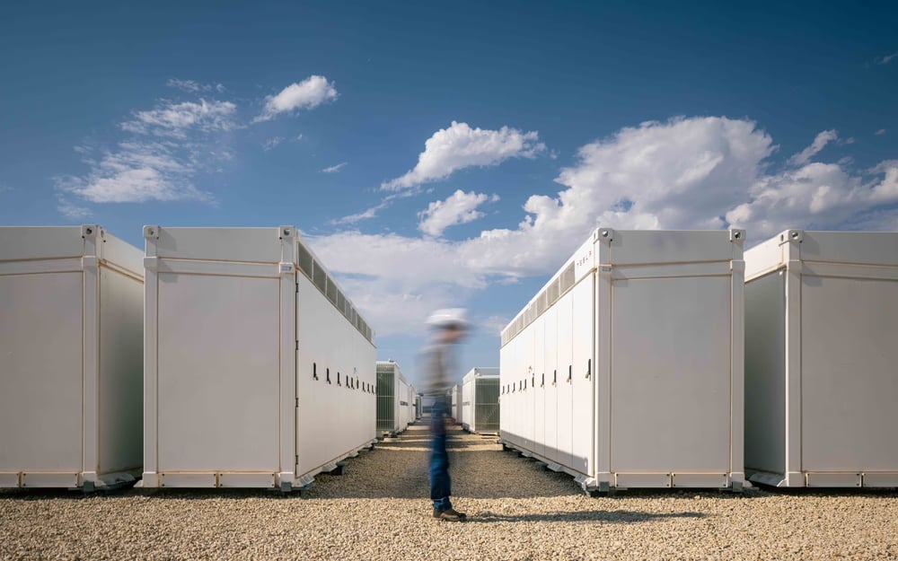 A blurred worker standing beside container ban.