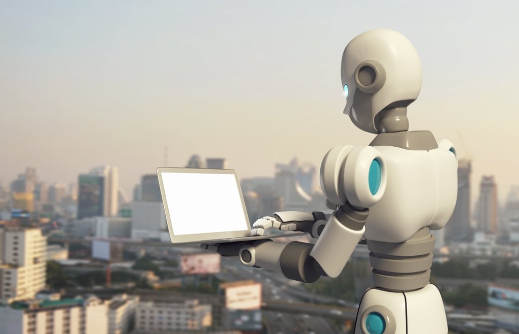 White robot holding a laptop in front of a city skyline
