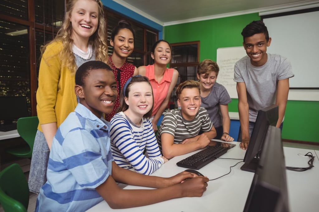 A group of young students inside a classroom.