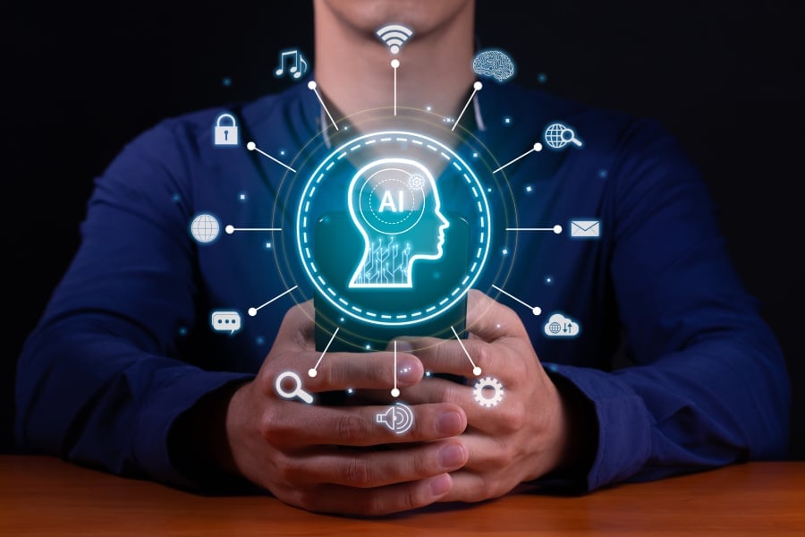 A man sitting with logos of AI assistant in the middle.