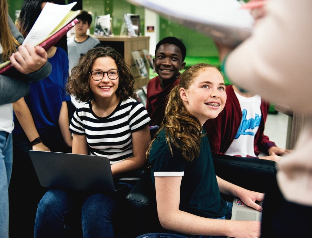 Group of students learning in classroom.