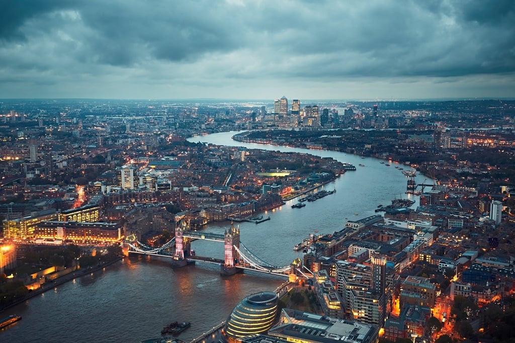 London skyline with illuminated Tower bridge and Canary Wharf at the dusk.