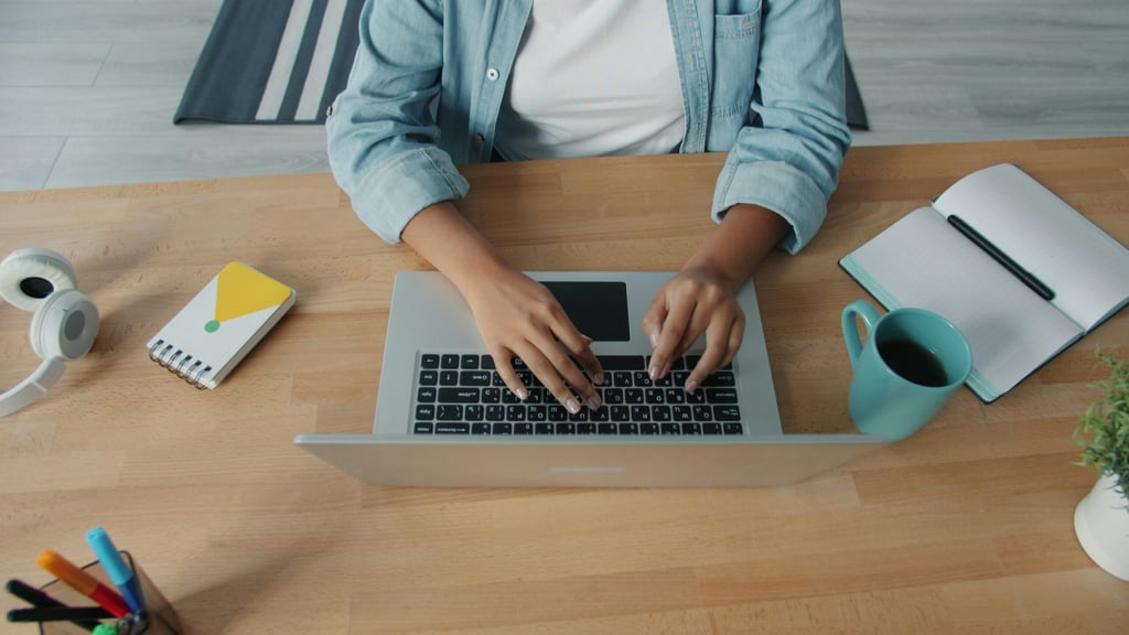 A man in his office working on his laptop,