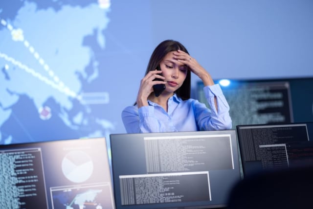 Stock photo of a cybersecurity employee looking worried.