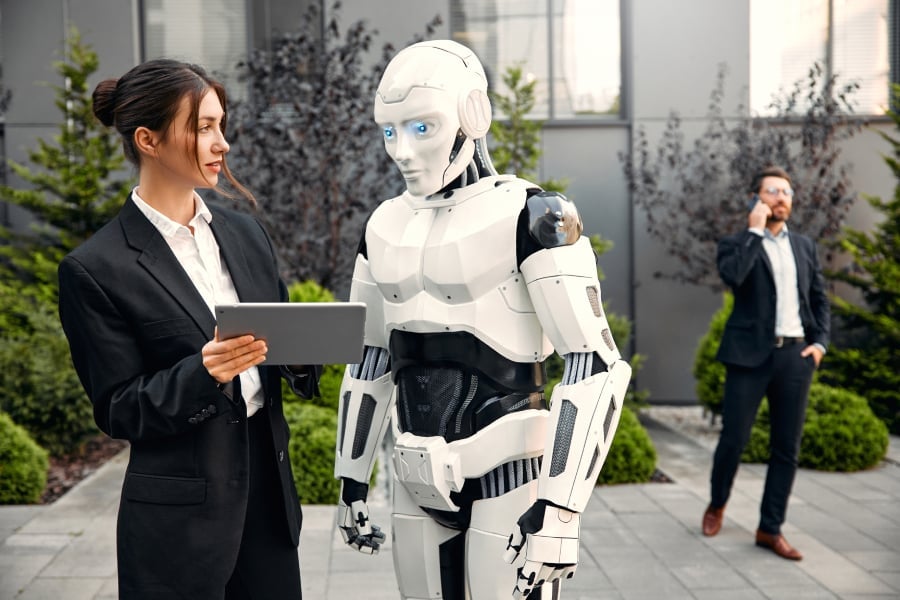 Robot with businessmen on the street near the building.