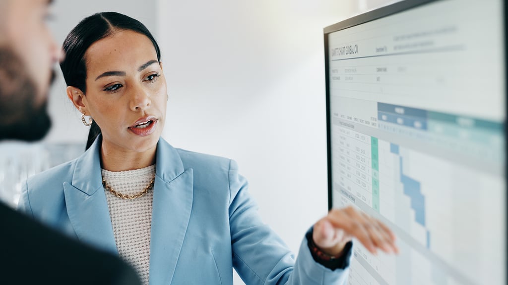 Data scientist showing coworker data on a screen