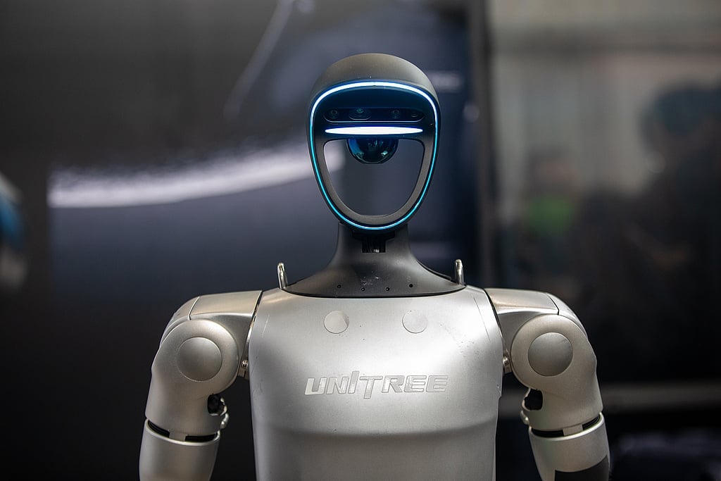 Close-up of a Unitree G1 humanoid robot head and torso, highlighting its integrated LIVOX 3D LiDAR sensor, depth camera, and LED face mask.