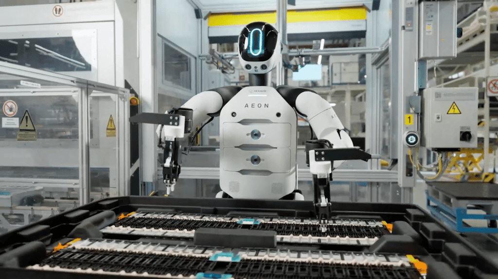 A humanoid robot working on a factory floor.