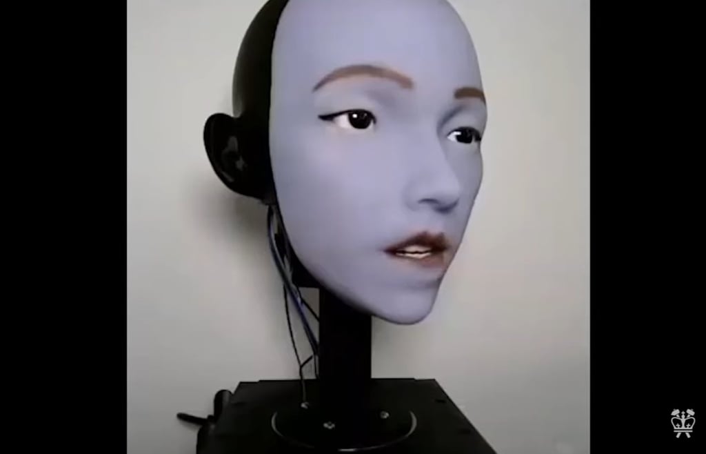 Robotic face, named Emo, with lilac skin and human-like features, used for lip-syncing research at Columbia University.