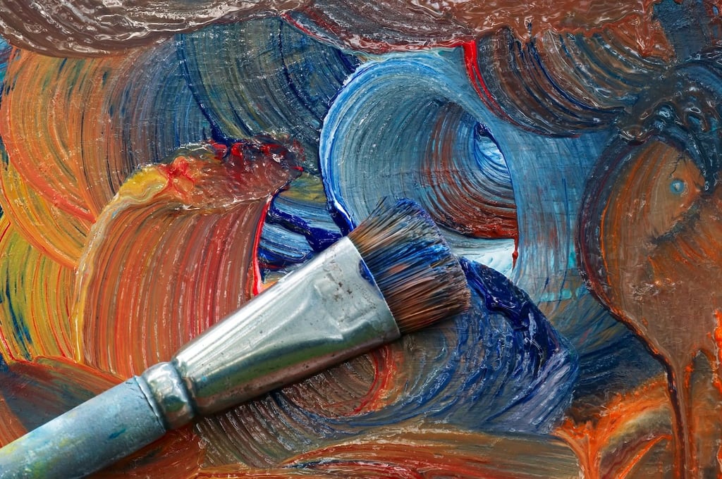 Stock photo of a paintbrush on a painting.