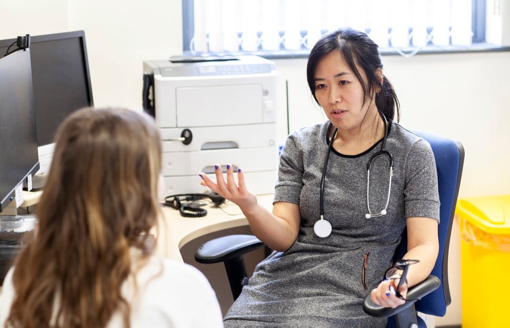 Doctor discussing with patient in a medical office.