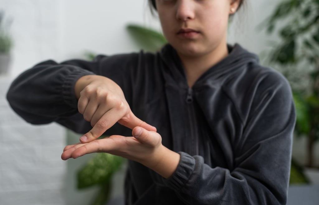 Deaf mute girl using sign language.