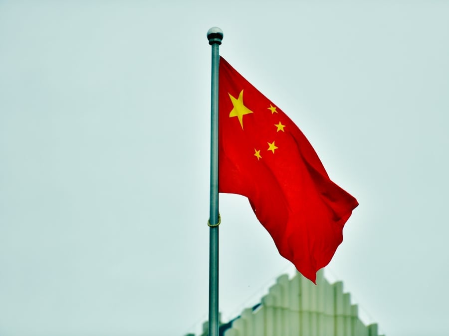 Flag of China raised on a pole.