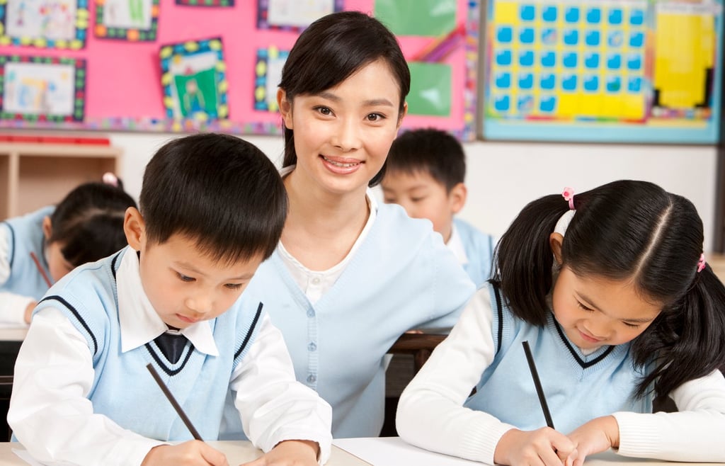 Teacher assisting students in class.