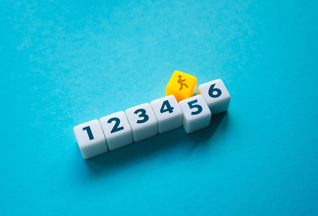 Numbered blocks with a block of man walking on top of it.