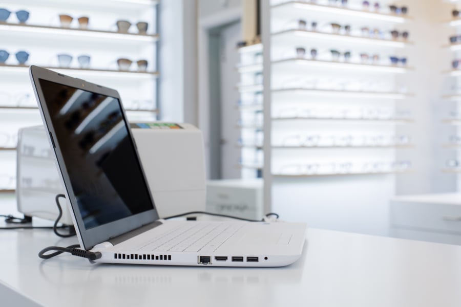 Laptop placed on a table inside a sunglass store.