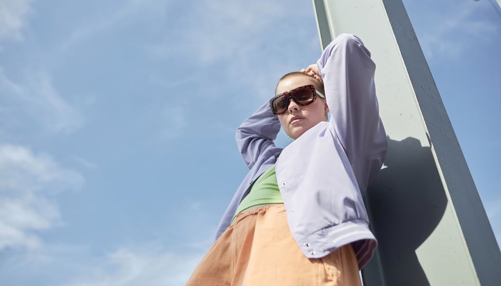 A person posing in front of camera with sky as the background