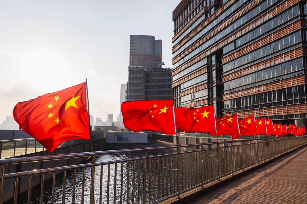 Row of Chinese flags on Huangpu river promenade, Shanghai, China.