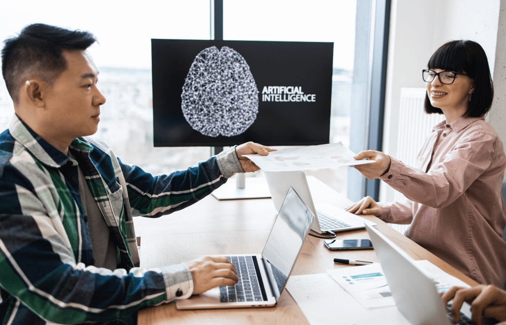 Coworkers collaborating on artificial intelligence project in modern office